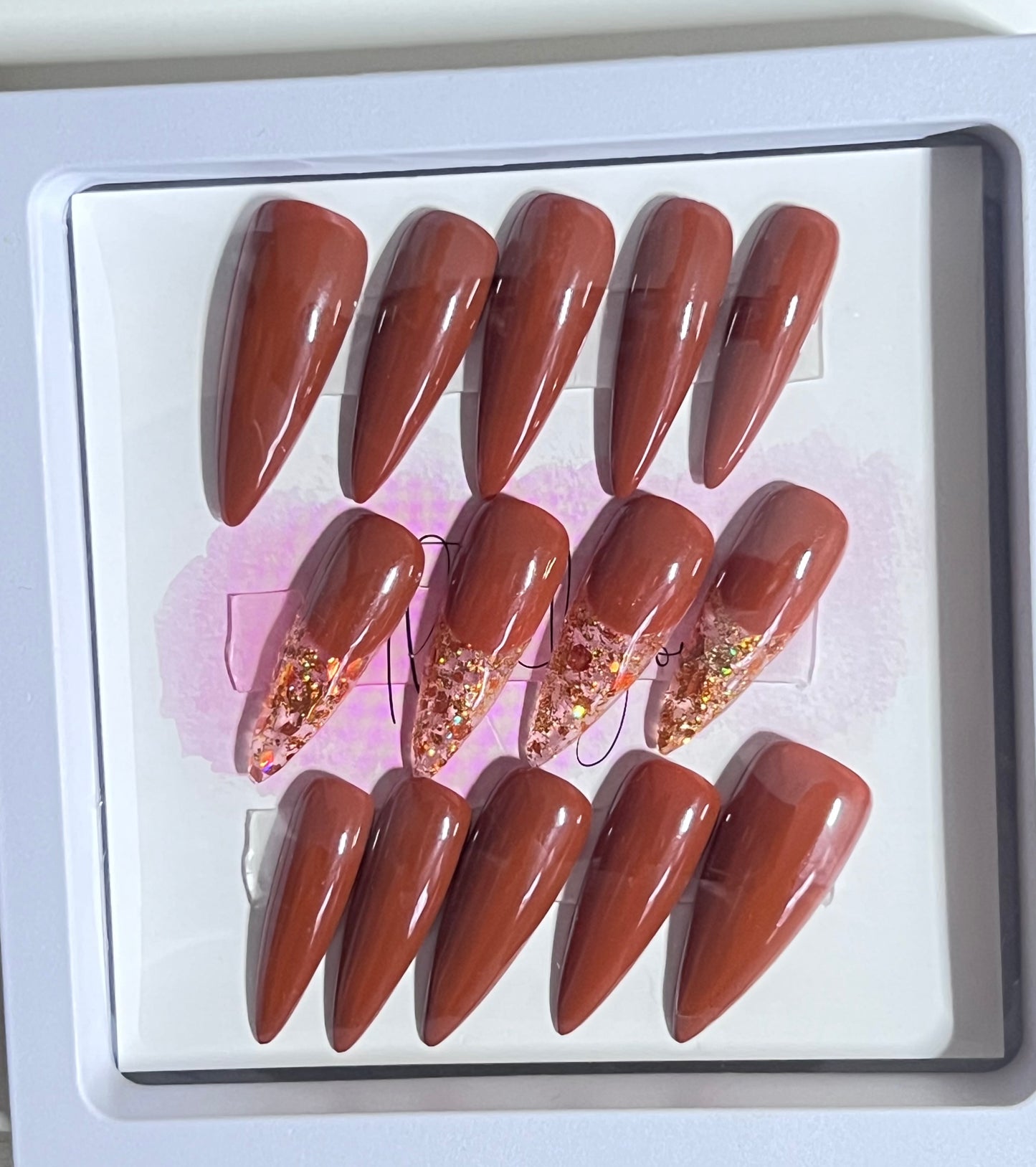 Set of 24 size large medium length stiletto nail. Included are 4 accent nails with the same brown gel polish and gold & copper fleck as the French.
