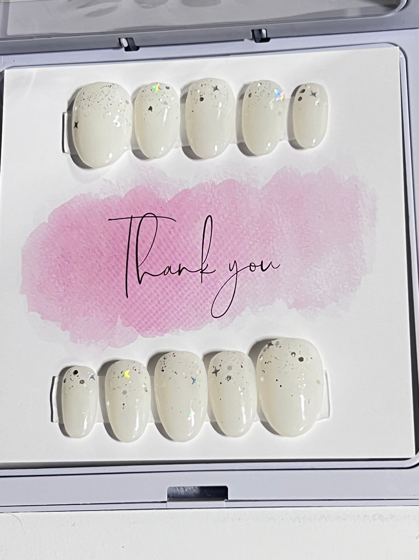 Size medium natural short round with a milky white gel polish and a little glitter close to the cuticle. No stain top coat.