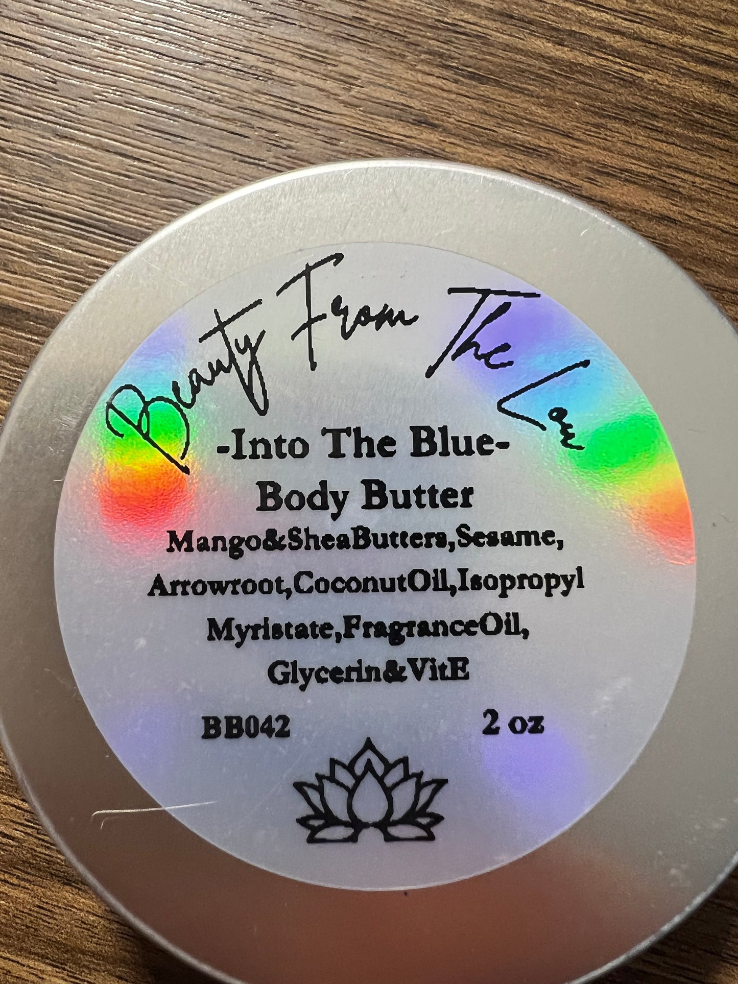Body butter container with label on a wooden surface