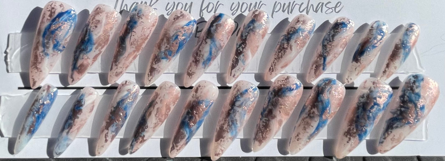 Set of 20 Long Stiletto shaped press-on nails with a layer of acrylic with hard gel over that. Gel polish; rose, white and blue marbled and hard gel top coat
