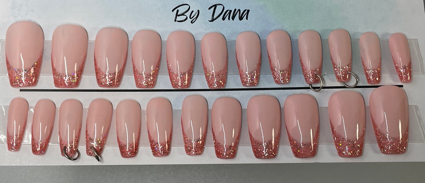 Set of 24 hand painted pink french nails. 4 are pierced with silver jump rings in them.
