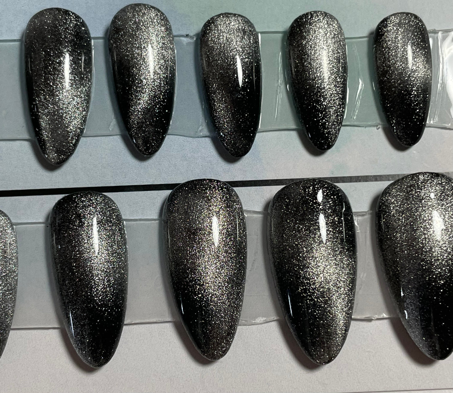 Beautiful set of hand painted black gel polish with chrome effect over all 20 nails.