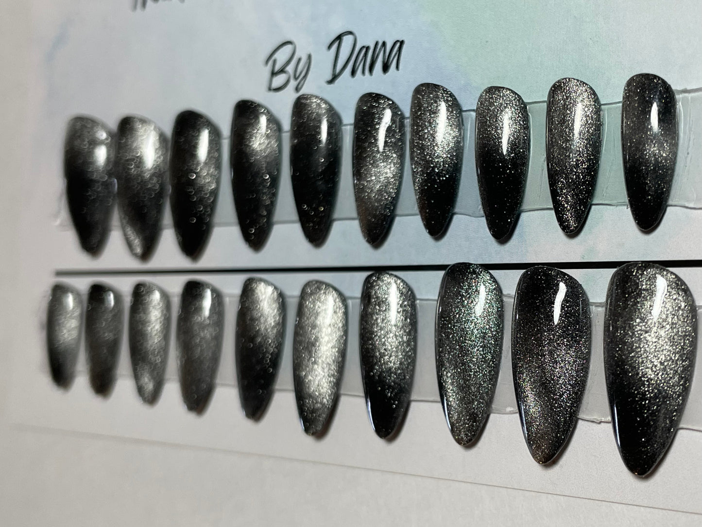 Hand painted black gel polish with a chrome effect over all 20 nails.