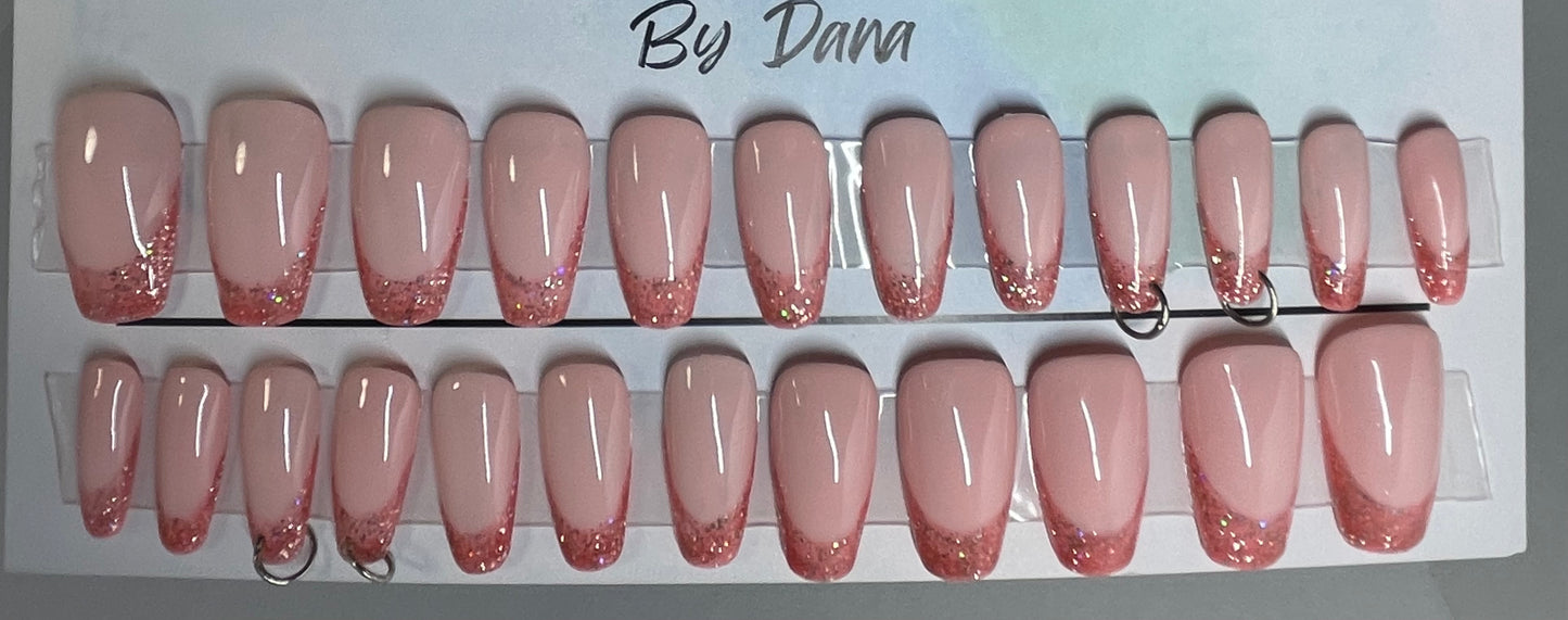 Professionally hand painted pink french nails. Set of 24 nails. 4 accents are pierced and have a jump ring in them. Secured with hard gel.