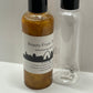 The empty 3.4 oz. bottle next to the full bottle, has the bead to help shake up that all homemade shimmer so it's a more even shine. 