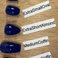 Five glossy dark blue coffin-shaped press-on nails displayed on a clear plastic strip, arranged vertically on a light wood surface with white labels reading ShortSquare, ExtraSmallOval, ExtraShortAlmond, MediumCoffin, and ExtraShortCoffin.