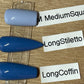Three artificial nail tips in different shapes and lengths displayed on a clear stand over a wood surface, with handwritten labels reading MediumSquare, LongStiletto, and LongCoffin.