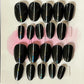 Set of 20 natural short round press-on nails with black gel polish and a pin stripe down the center. 