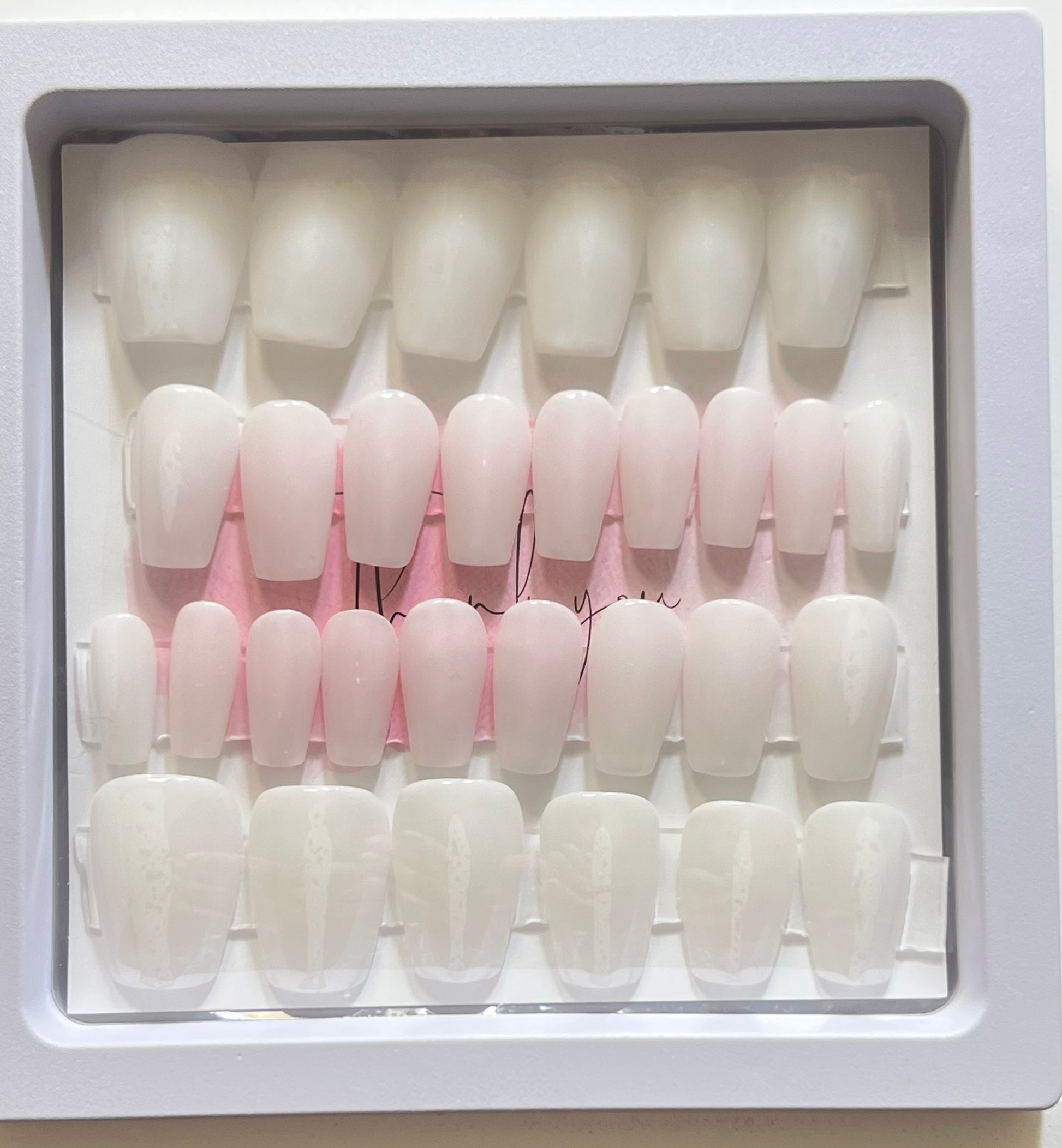 Set of 30 extra short coffin nails with milky white gel polish and no stain top coat. 