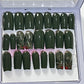 Set of 24 medium length square nails and 4 accent nails with hand painted holy with a sprinle of gold glitter. The other 20 nails are a solid dark green gel polish and not stain top coat.