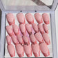 Set of 24 medium length coffin shaped nails with light pink/peach base and darker pink with glitter french tip. Included are 4 nails that are pierced with silver O rings and all are sealed with hard gel top coat.