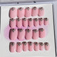 Set of 24 extra short oval nails with a light pink gel polish and stones at the cuticle sealed with a hard gel top coat. 