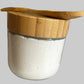10 oz Glass jar of body butter with bamboo spoon on top for application.
