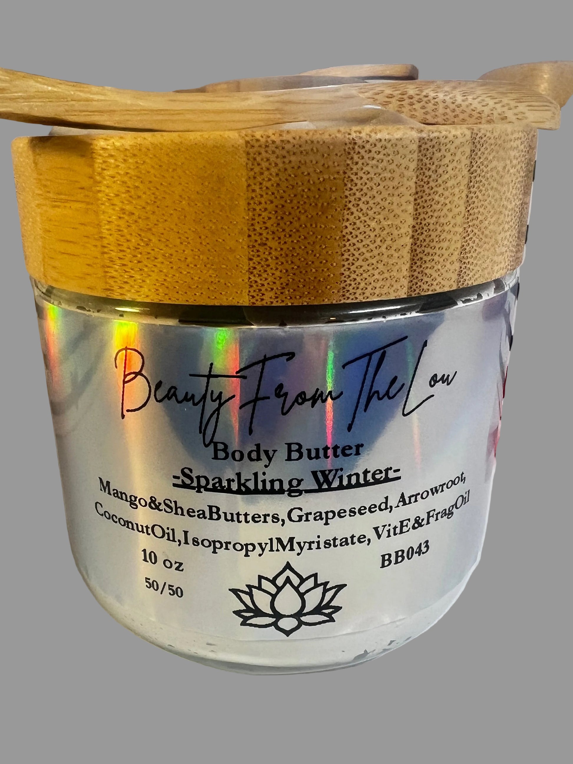 10 oz Glass Jar with bamboo lid of body butter with spoon on top for application