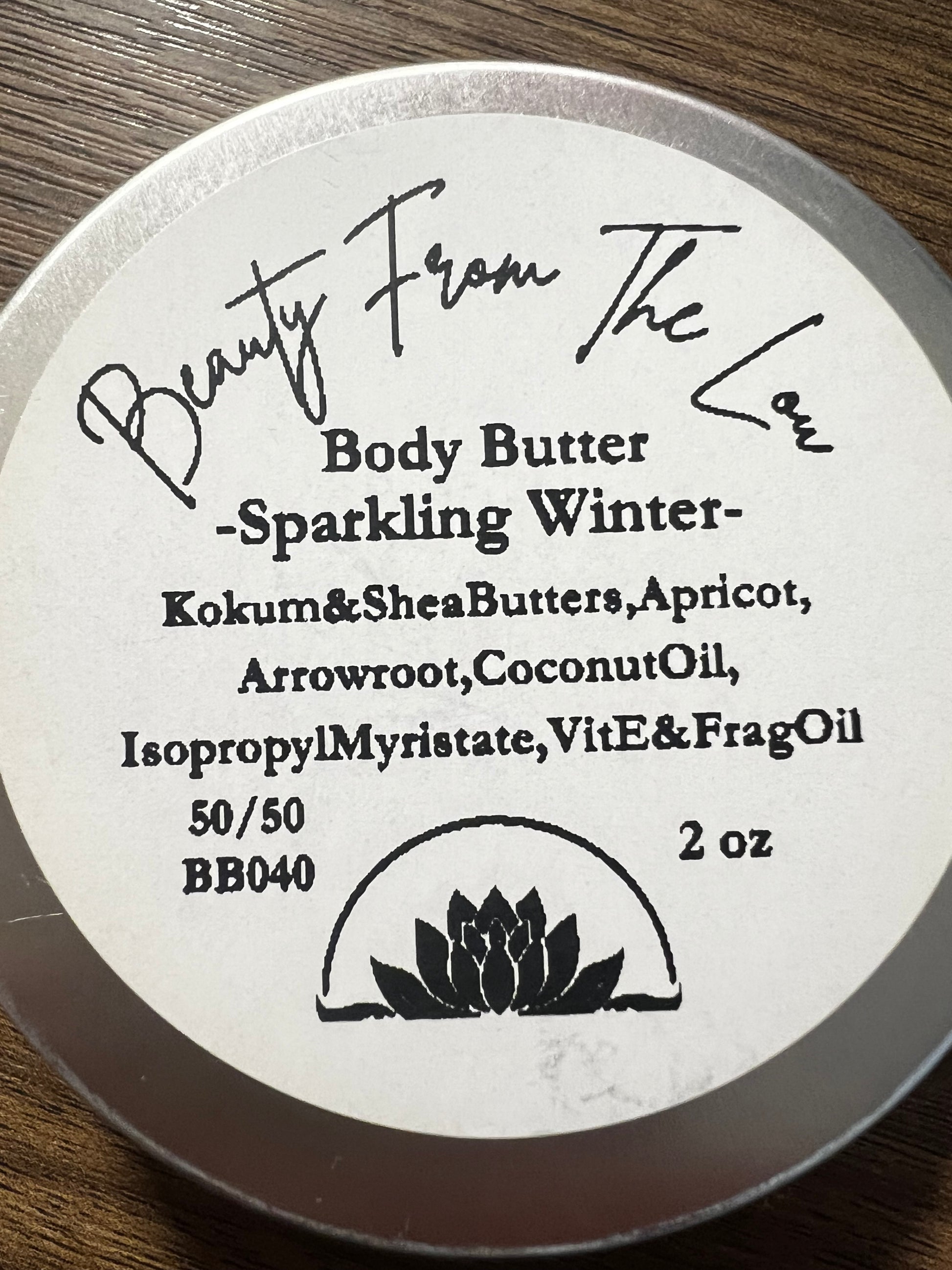 Body butter container with label on a wooden surface