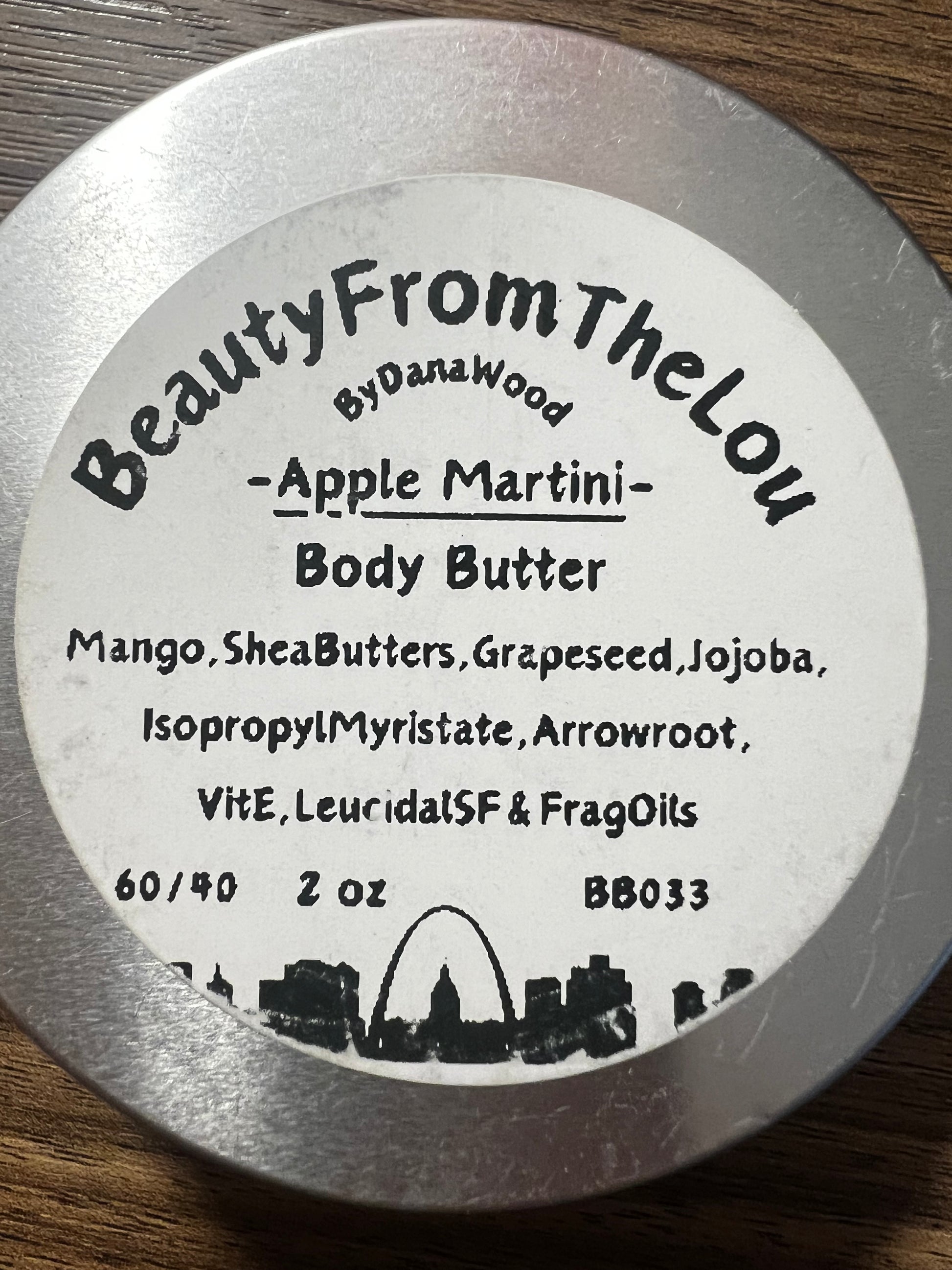 Body butter container label with branding and product details on a wooden surface