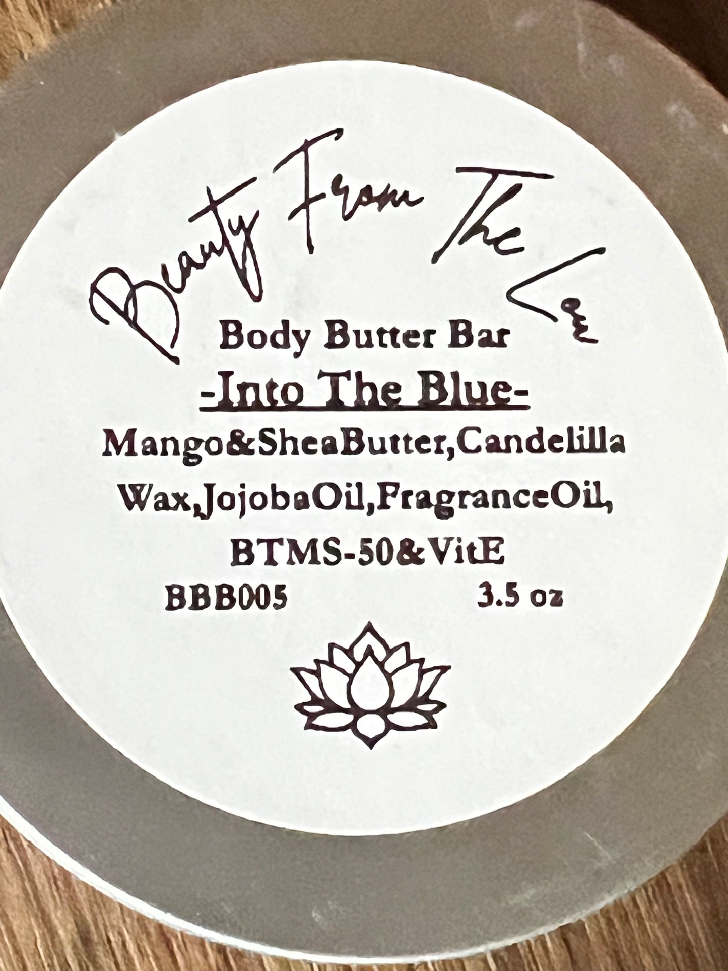 Body butter bar label with branding and product details on a wooden surface