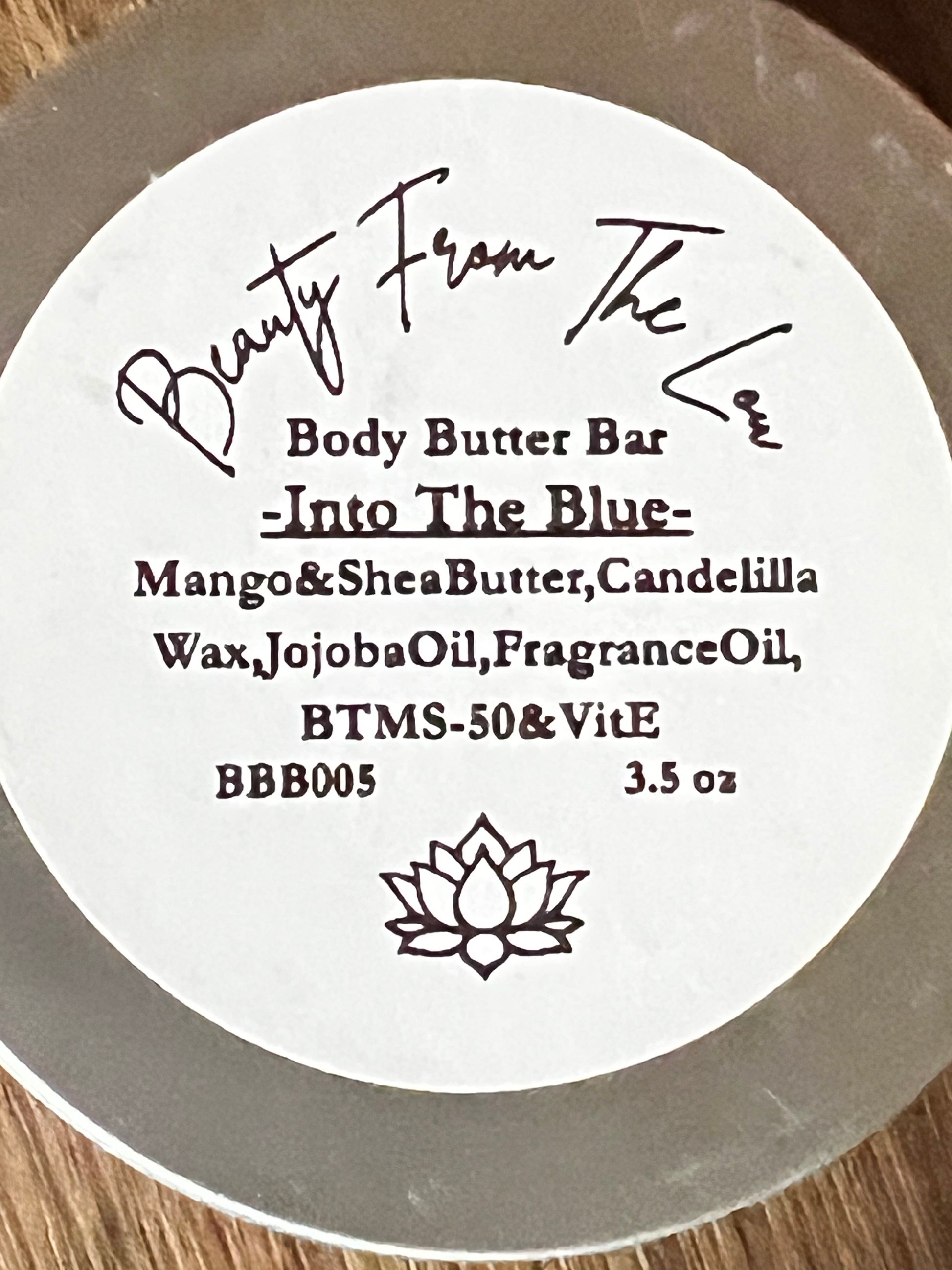 Body butter bar label with branding and product details on a wooden surface