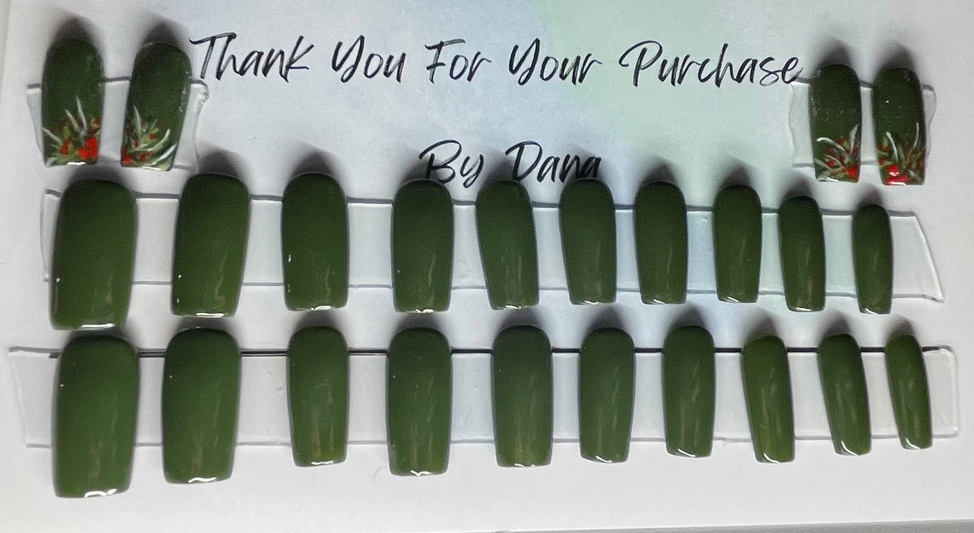Hand painted dark green gel polish and holly painted on 4 extra nails. 