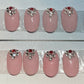 Fun hand painted Nails for a friend or for yourself. Soft pink and clear and red stones by the cuticle.