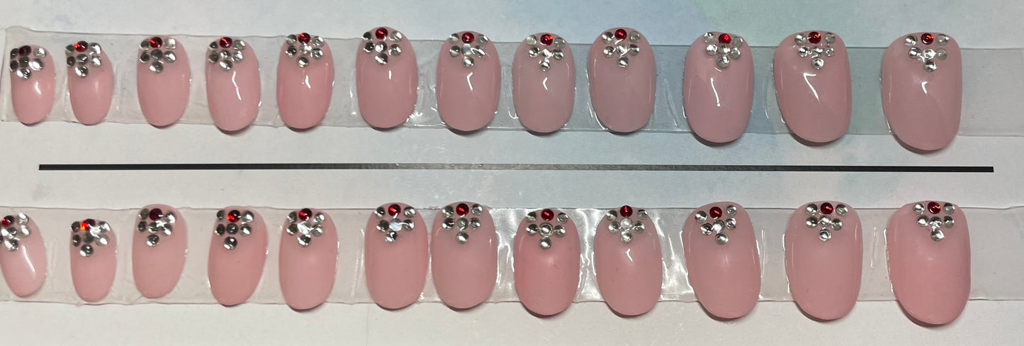 Fun hand painted Nails for a friend or for yourself. Soft pink and clear and red stones by the cuticle.