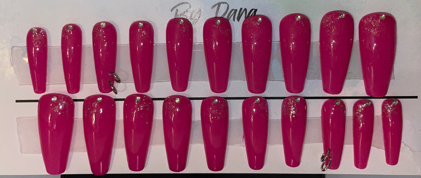 Hand painted professional set of 20 nails. 2 pierced nails with 2 jump rings in each. A great dark pink gel polish.
