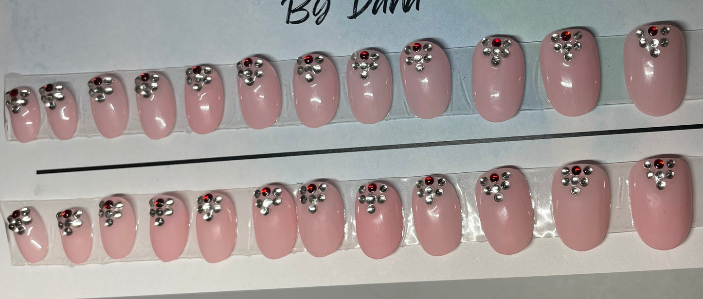 A great set for Valentine's Day. Hand painted with pink gel polish and a few stones at cuticle.